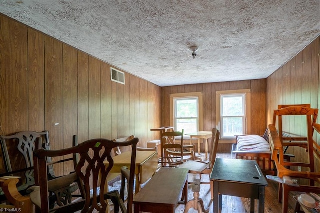 dining space with wood walls