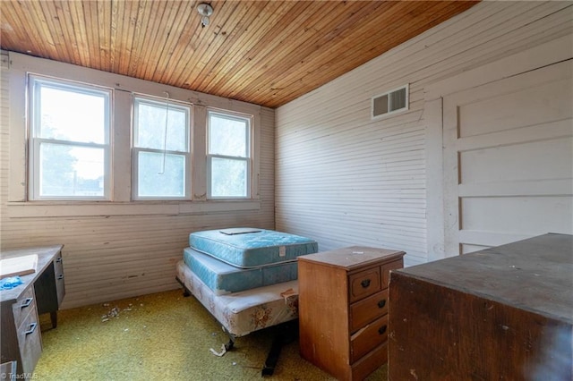 bedroom featuring wooden walls