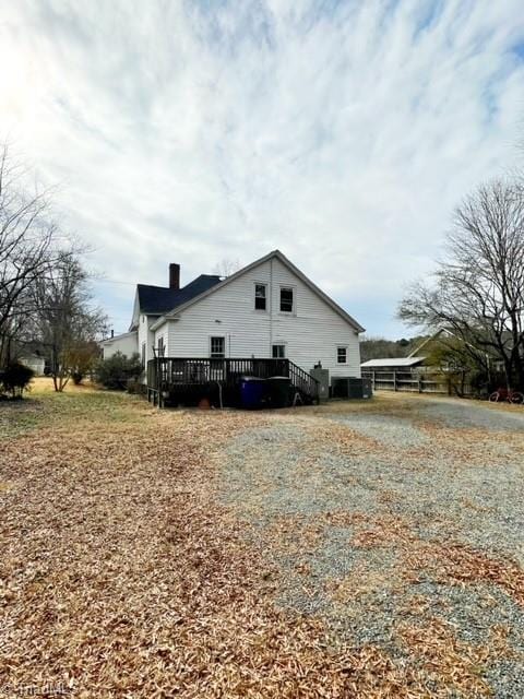 view of side of property with a wooden deck