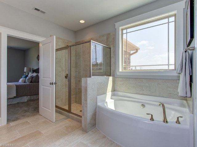 ensuite bathroom featuring visible vents, a shower stall, ensuite bathroom, and a garden tub