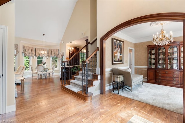 4607 Eden Bridge Dr, Kernersville, NC 27284 - entryway with a chandelier, wood finished floors, stairway, arched walkways, and high vaulted ceiling
