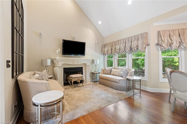4607 Eden Bridge Dr, Kernersville, NC 27284 - living area featuring wood finished floors, a fireplace with flush hearth, high vaulted ceiling, and recessed lighting