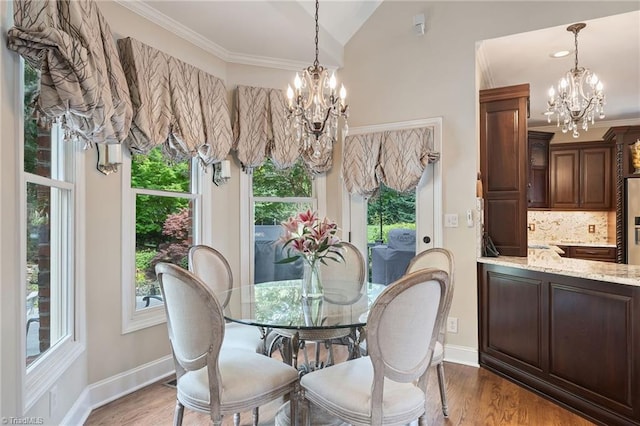 4607 Eden Bridge Dr, Kernersville, NC 27284 - dining area with a chandelier, wood finished floors, crown molding, and vaulted ceiling