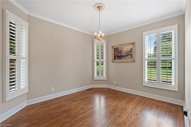 4607 Eden Bridge Dr, Kernersville, NC 27284 - spare room featuring healthy amount of natural light, a chandelier, wood finished floors, and crown molding