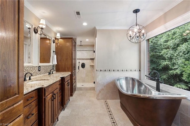 4607 Eden Bridge Dr, Kernersville, NC 27284 - bathroom featuring a stall shower, vanity, a freestanding tub, tile walls, and crown molding