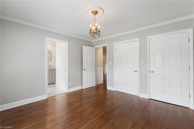4607 Eden Bridge Dr, Kernersville, NC 27284 - unfurnished bedroom with a chandelier, wood finished floors, crown molding, ensuite bathroom, and a closet