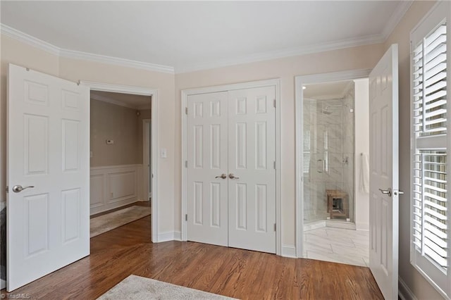 4607 Eden Bridge Dr, Kernersville, NC 27284 - unfurnished bedroom featuring ornamental molding, a closet, wood finished floors, and connected bathroom