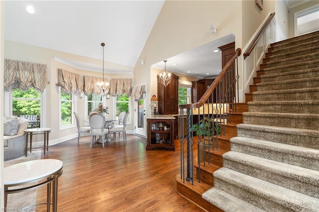 4607 Eden Bridge Dr, Kernersville, NC 27284 - stairway featuring a chandelier, wood finished floors, and high vaulted ceiling