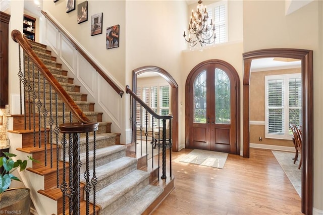 4607 Eden Bridge Dr, Kernersville, NC 27284 - entrance foyer featuring plenty of natural light, light wood-style floors, stairway, a high ceiling, and a chandelier
