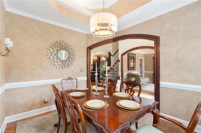 4607 Eden Bridge Dr, Kernersville, NC 27284 - dining area featuring arched walkways, a chandelier, stairway, and crown molding