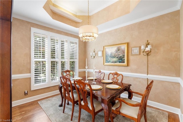 4607 Eden Bridge Dr, Kernersville, NC 27284 - dining space with a chandelier, wood finished floors, ornamental molding, and a tray ceiling