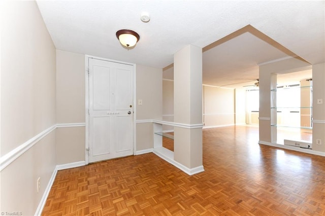 unfurnished room with ceiling fan and baseboards