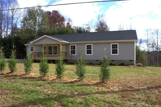 view of front facade with a deck and a front lawn