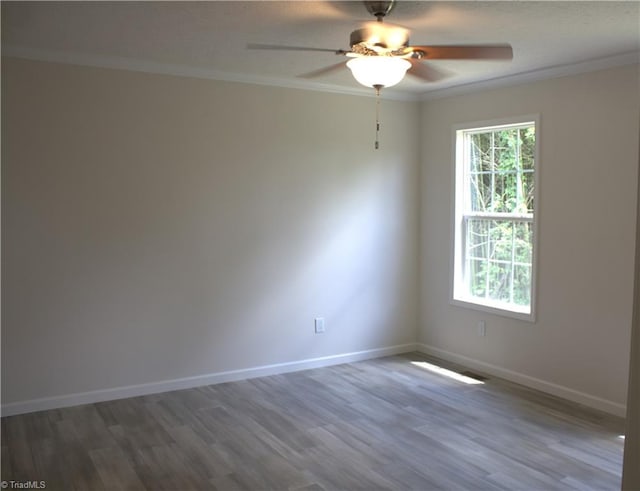 spare room with ceiling fan, crown molding, and dark hardwood / wood-style floors