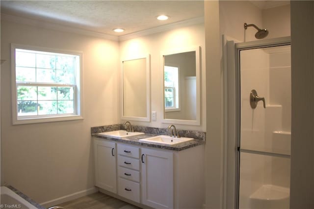 bathroom featuring a shower with door, vanity, wood-type flooring, and a textured ceiling