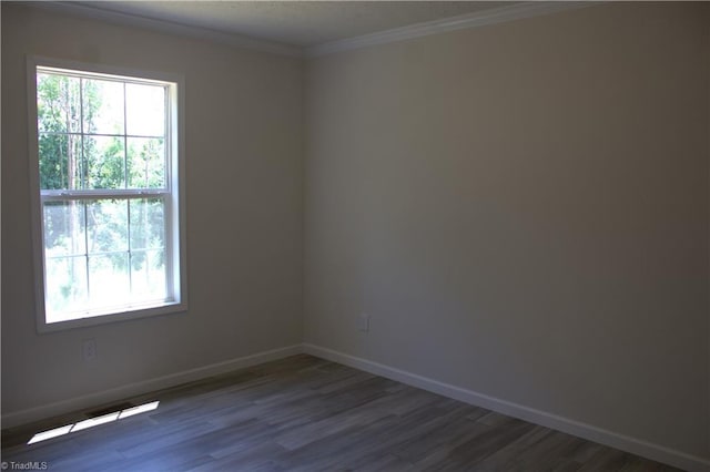 unfurnished room featuring hardwood / wood-style flooring and ornamental molding