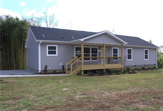 back of house with a lawn and a deck