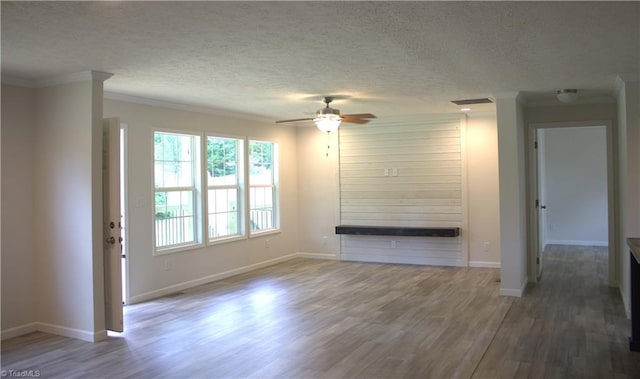 unfurnished living room featuring ceiling fan, crown molding, a textured ceiling, and hardwood / wood-style flooring