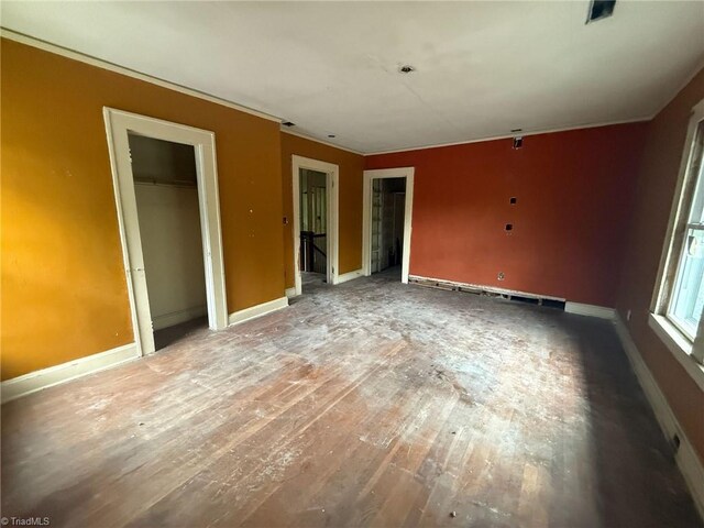 302 Louise Ave, High Point, NC 27262 - unfurnished bedroom with baseboards, a baseboard heating unit, wood finished floors, and ornamental molding