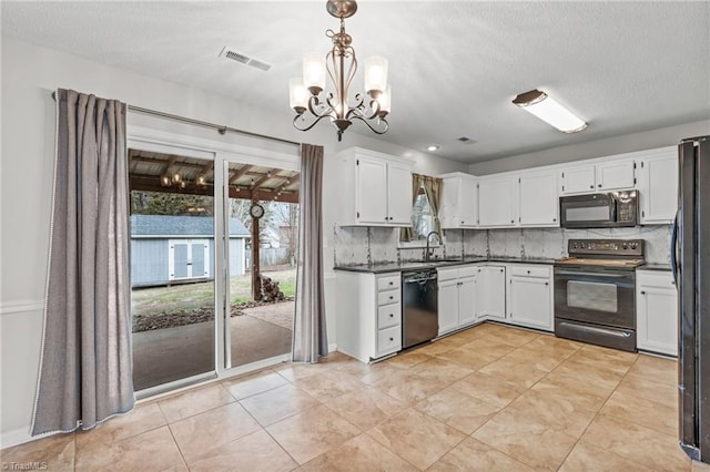 kitchen featuring sink, pendant lighting, white cabinets, and black appliances