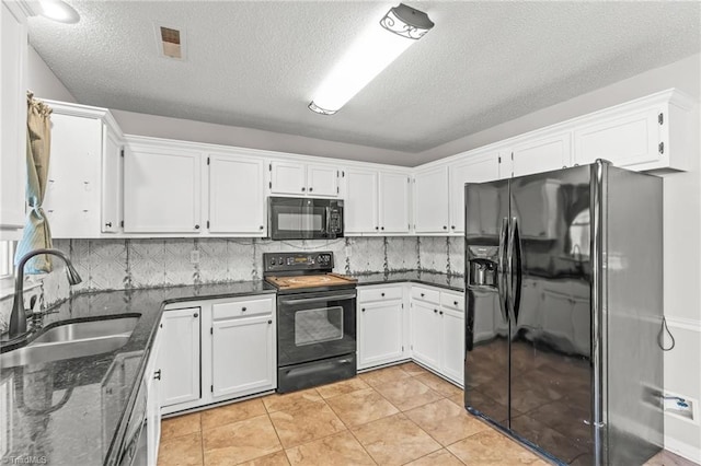 kitchen with light tile patterned flooring, sink, white cabinetry, tasteful backsplash, and black appliances