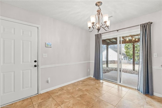 unfurnished dining area with an inviting chandelier, light tile patterned flooring, and a textured ceiling