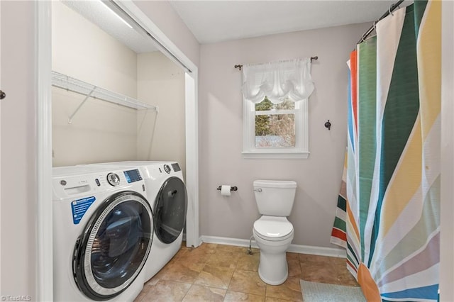 interior space featuring light tile patterned floors and washer and clothes dryer