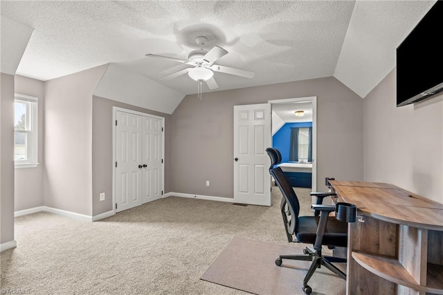 office with ceiling fan, lofted ceiling, light carpet, and a textured ceiling