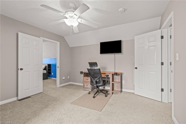 carpeted office space featuring lofted ceiling and ceiling fan