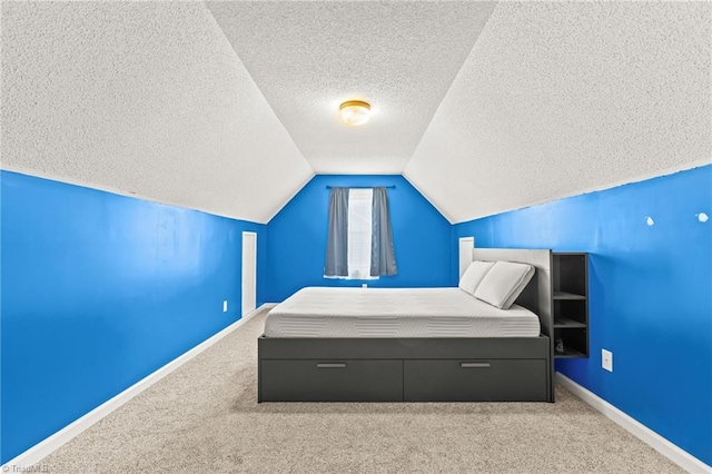 bedroom featuring carpet flooring, vaulted ceiling, and a textured ceiling