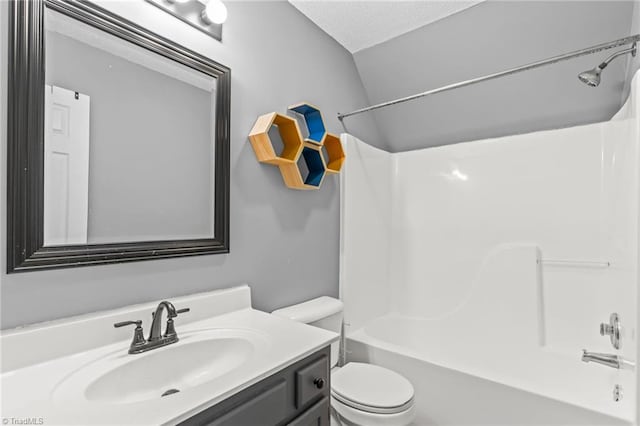 full bathroom with tub / shower combination, vanity, a textured ceiling, vaulted ceiling, and toilet