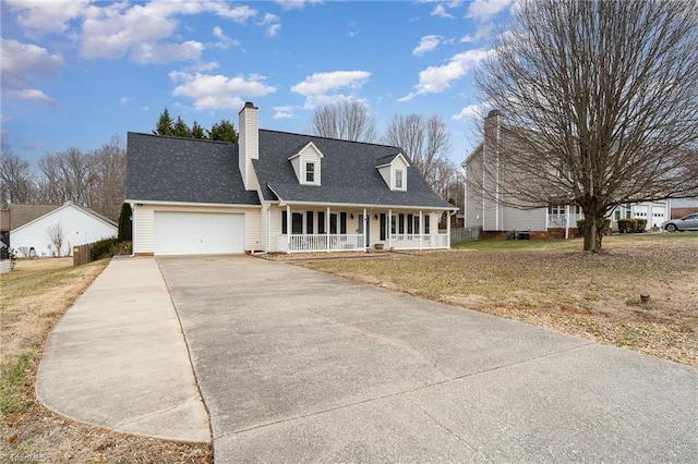 cape cod house with a porch, a garage, and a front lawn