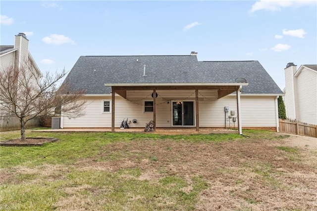 back of property featuring a lawn and a patio