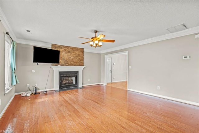 unfurnished living room featuring ornamental molding, hardwood / wood-style floors, ceiling fan, and a textured ceiling