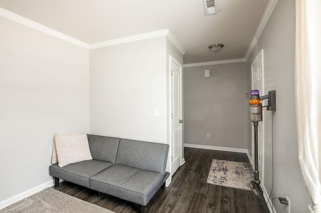 living area featuring crown molding, wood finished floors, baseboards, and visible vents