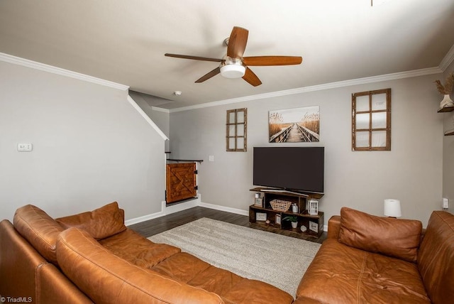 living room featuring ornamental molding, a ceiling fan, baseboards, and wood finished floors