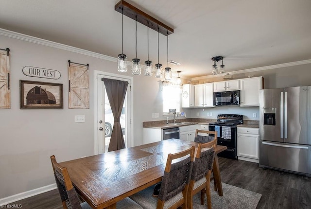 dining space with a barn door, visible vents, and ornamental molding