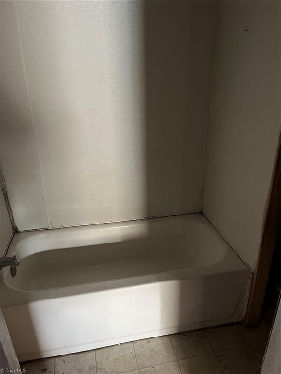 bathroom featuring tile patterned flooring and a washtub