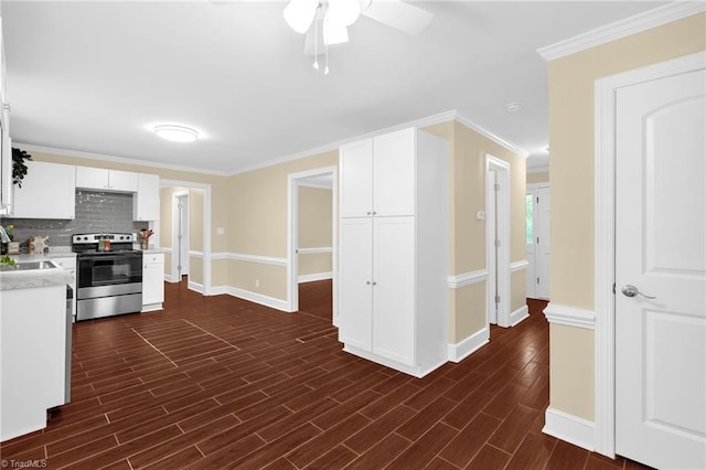 2305 Hunters Ridge Dr, Pleasant Garden, NC 27313 - kitchen featuring electric range, a ceiling fan, light countertops, baseboards, and white cabinetry