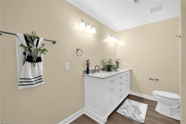 2305 Hunters Ridge Dr, Pleasant Garden, NC 27313 - bathroom with vanity, wood finished floors, toilet, baseboards, and ornamental molding