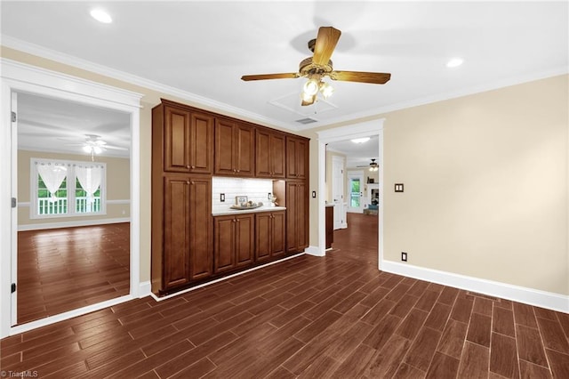 2305 Hunters Ridge Dr, Pleasant Garden, NC 27313 - empty room with a ceiling fan, healthy amount of natural light, baseboards, dark wood-style flooring, and ornamental molding