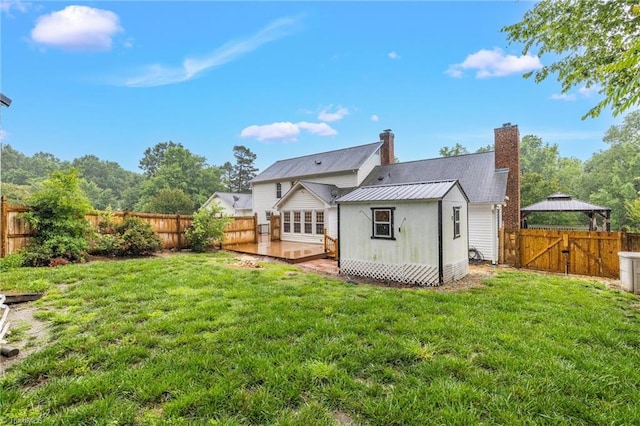 2305 Hunters Ridge Dr, Pleasant Garden, NC 27313 - rear view of property with metal roof, a wooden deck, a chimney, and a gate