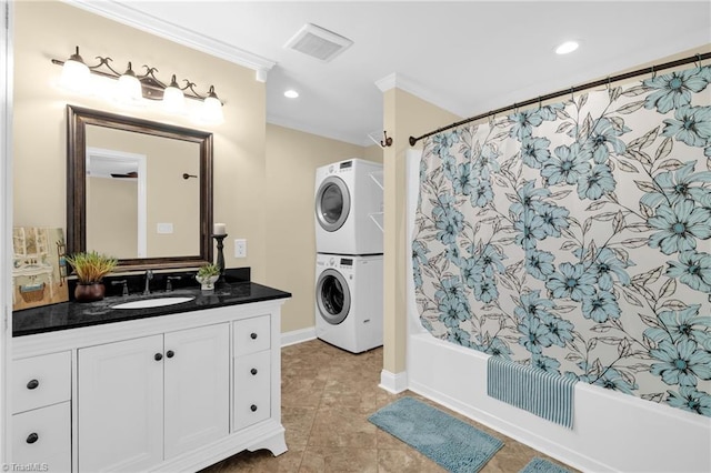 2305 Hunters Ridge Dr, Pleasant Garden, NC 27313 - full bath with stacked washer and clothes dryer, vanity, shower / bath combo, crown molding, and baseboards