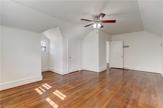 bonus room featuring vaulted ceiling, a ceiling fan, baseboards, and wood finished floors