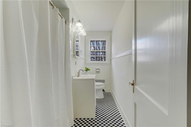 bathroom with vanity, baseboards, curtained shower, tile patterned floors, and toilet