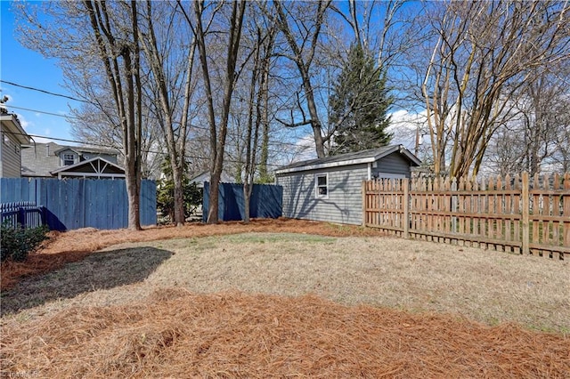 view of yard with an outdoor structure and fence