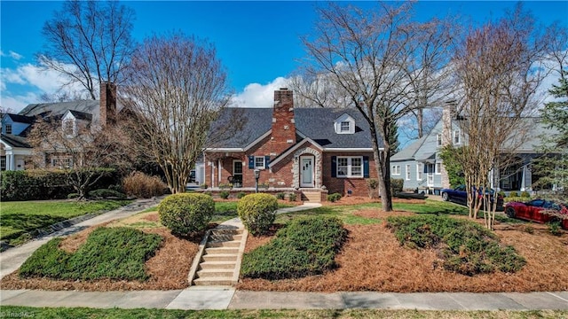 cape cod-style house featuring brick siding, crawl space, and a chimney