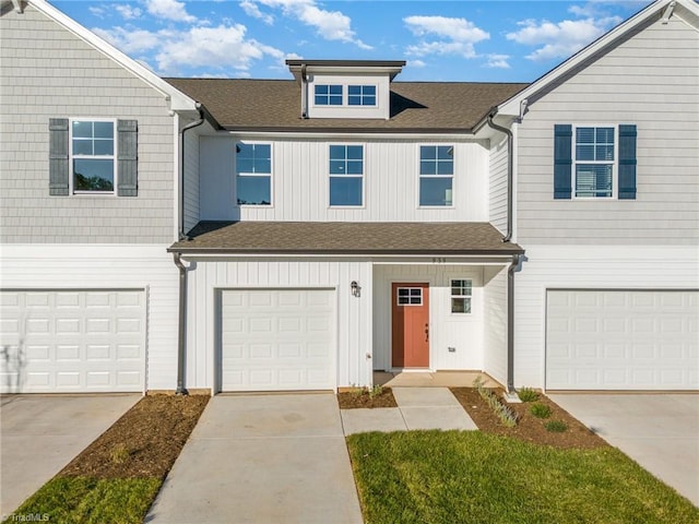 939 Cannon Crossing Cir, Greensboro, NC 27410 - townhome / multi-family property featuring a garage, board and batten siding, a shingled roof, and concrete driveway