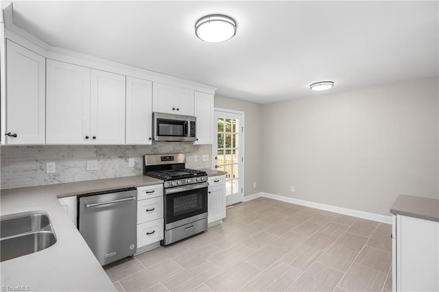 kitchen with white cabinetry, sink, stainless steel appliances, and decorative backsplash