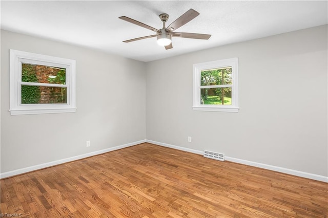 empty room featuring ceiling fan and light hardwood / wood-style flooring